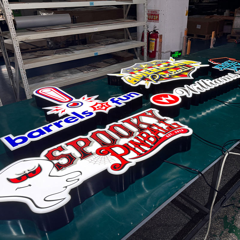 custom LED acrylic logo signs Factory batch production of custom LED acrylic signs including American Pinball, Williams, Barrels of Fun, and Spooky Pinball